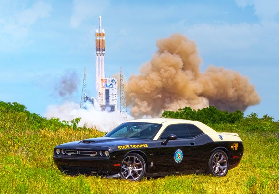 winning photo of FHP vehicle in front of rocket